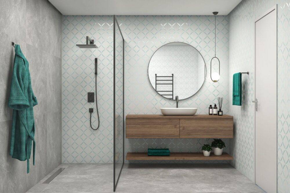 Bathroom with white and blue patterned tile and grey tile floor. 