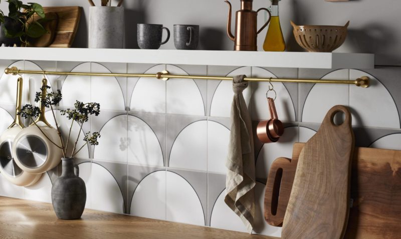 Kitchen backsplash detail shot with patterned tile and white shelf with decor