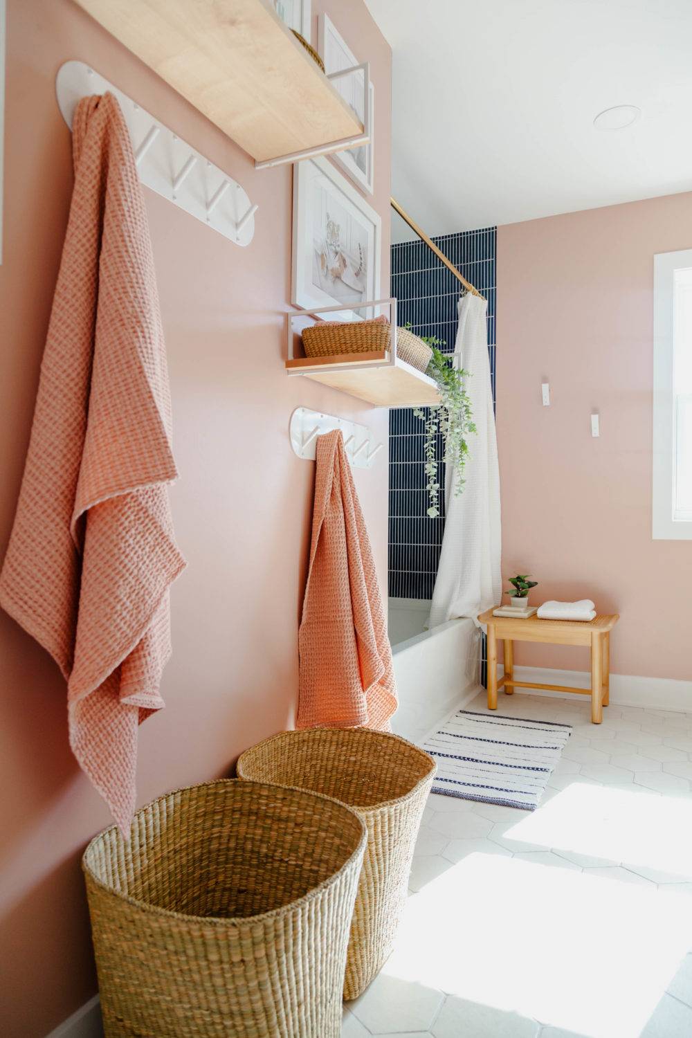 Kids bathroom with pink walls and white hex tile