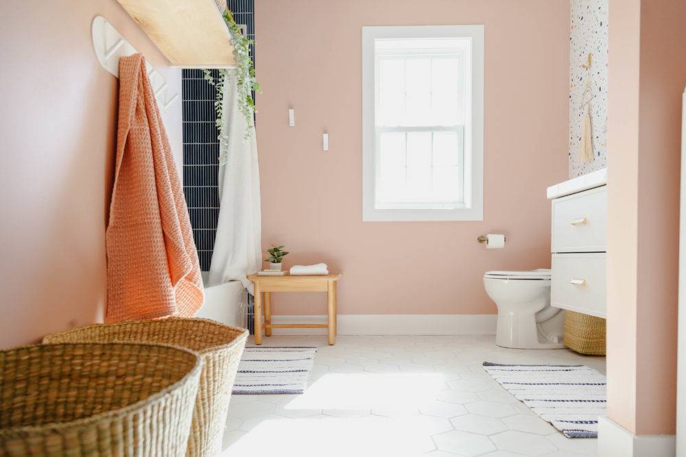 Kids bathroom with pink walls and white hex tile