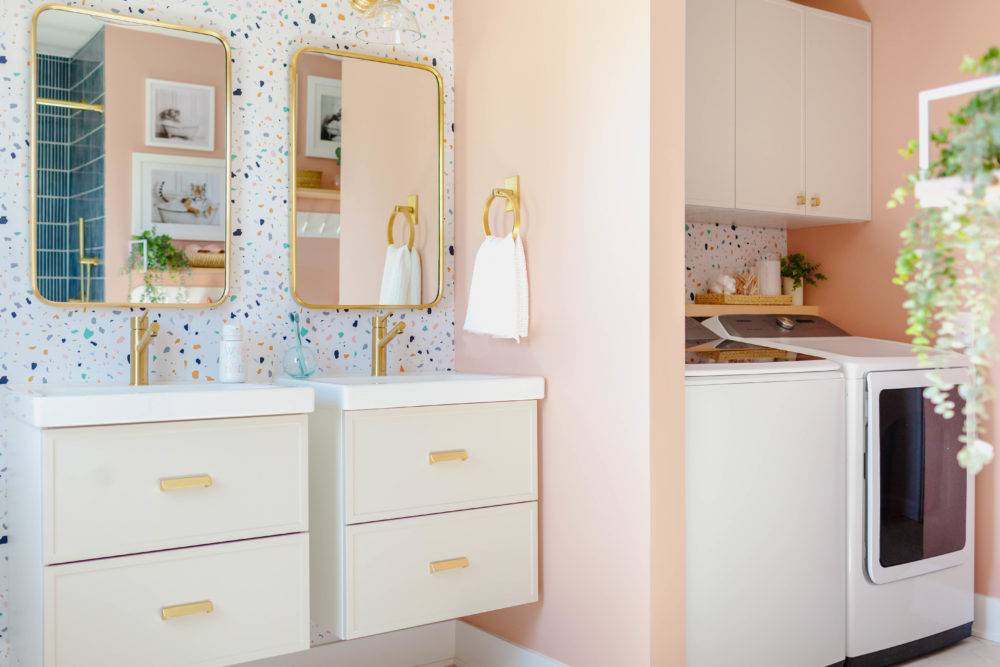 Kids bathroom with pink walls and colorful terrazzo patterned wallpaper