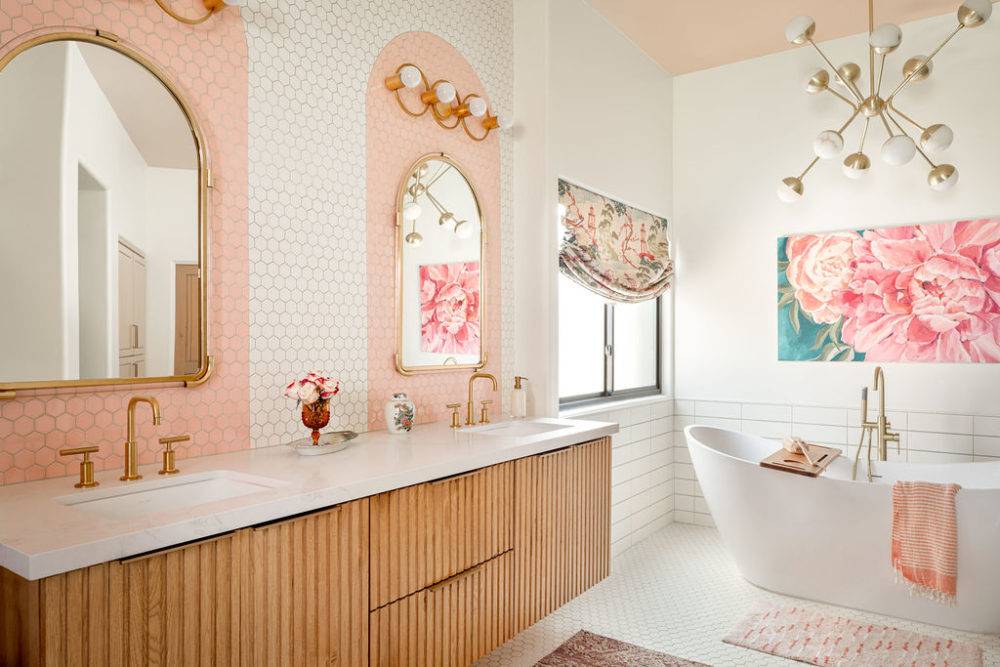Large bathroom with pink tiled backsplash and freestanding bathtub