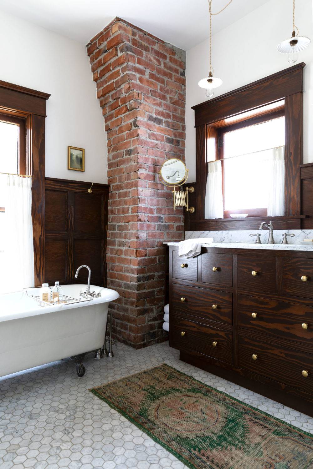 Traditional bathroom with marble hex flooring and brick pillar