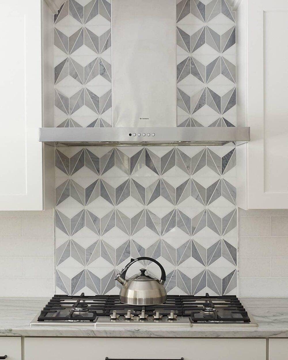 White and grey tile in a pattern kitchen stove backsplash.